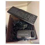 2 baskets with headphones, keyboard, gaming remotes, VR headset, misc