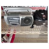 Cassette radio, bike helmet, keyboard, Johnny Carson VHS tapes