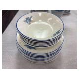 10 Small plates and 6  fruit bowls with blue rim and blue birds by The Potters Co- Operative Co. and 4 cups and saucers by Wedgwood with a creamer by Spode , 3 saucers by The Standard made in USA that