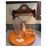 Round wood cutting board, bagel stand, salt shakers, straw container, paper towel holder