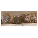 3 clear glass vases with shells and 2 shell bottles