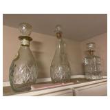 3 liquor bottles with stoppers