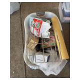 Basket of misc: dog training pads 2 posters, metal rack, bed shoe organizer in box, travel steamer in box, flag and other items