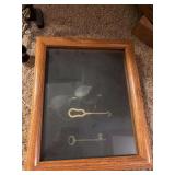 Shadow box with old glasses and keys and magnifying glass on stand with clips