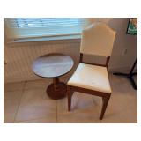 Round pedestal side table, wooden sode chair with nailhead trim and curved top