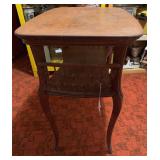 antique two-tier oak accent or side table with curved cabriole legs and a spindle or cutout gallery on the lower shelf. 28 x 19 x 29