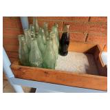 Coca Cola glass bottles and wood tray