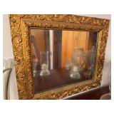 Gold ornately framed mirror