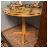 35” round wooden pedestal drop leaf table with glass top, excludes items on top of table