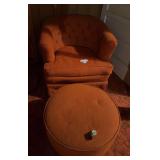 vintage tufted coral or pinkish-orange upholstered armchair and matching round ottoman, resembling mid-century ottoman has wheel that is off.  No tears