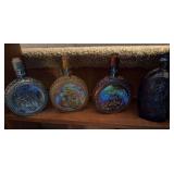3 iridescent liquor bottles, blue