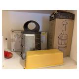 Pampered Chef food chopper, grater lid Tupperware butter keeper, kitchen scale, rolling pin, measuring cup, Pampered Chef decorater, strainers