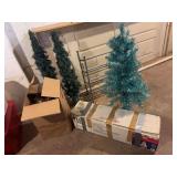 White Christmas tree , touquois colored tree and two trees in pots . And a white tree topper and shoe rack .