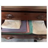 Two drawers of table linens , baby circus quilt and Christmas lap quilt