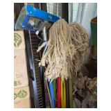 Mops, sponge and rag , bed frame and white wire shelf