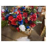 Lot of red, white and blue cemetery flowers and vases
