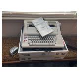 Smith Corona electric type writer, alarm clock , and a GE vintage digital clock radio