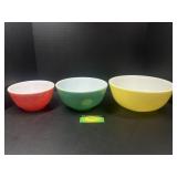 Three colored Pyrex bowls
