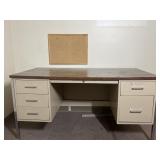 Metal desk with small cork board