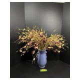 Blue vase with fake flowers in it