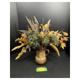 Floral pitchers with flowers and feathers