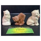 Three cat figurines