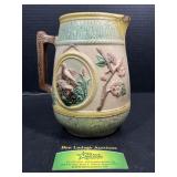 Antique English majolica pitcher with bird relief
