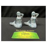 Two cast iron mermaids