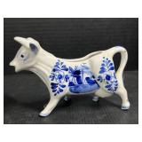 Blue and white creamer cow