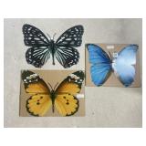 Three metal butterfly signs