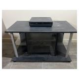 Black tv stand and RCA vcr player