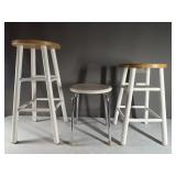 Two wooden stools and one metal stool