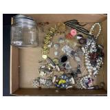 Jewelry pieces in two jars