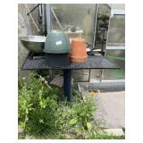 Metal outdoor table with contents