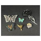 Butterfly and flower brooches