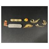 Gold tone brooches and more