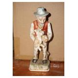 Old Man Holding a Dog Figurine