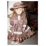 Porcelain Doll w/stand & bronze color dress