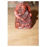 Miniature Asian Man Sitting Down
