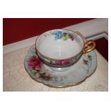 Cup and Saucer Set with Red and Blue Flowers