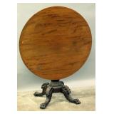 A LARGE MAHOGANY TILT-TOP TABLE WITH HEAVY CARVED