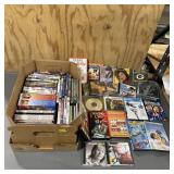 Assortment of DVDs, CDs, and VHS tapes; see photos