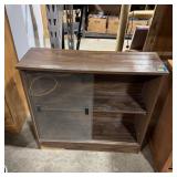 Two-shelf glass-front storage unit with two slidin