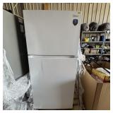 Medea refrigerator/freezer with small dent. See ph