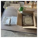 Box of new metal electrical switch plates. See pho