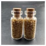 Two Glass Bottles Filled With Gold Flakes