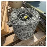 Roll of Barbed Wire Fencing on Metal Spool