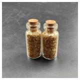 Two Glass Bottles With Gold-Colored Flakes