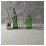 Assorted vintage glass bottles including 7UP,