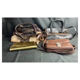 Collection of assorted handbags and purses in